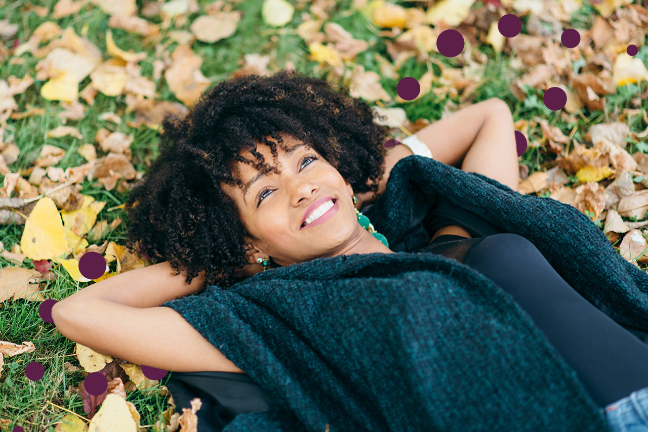 Woman relaxing in nature symbolizing lifestyle habits that support neuroplasticity and cognitive health.